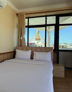 Voodi või voodid majutusasutuse Boudha Mandala Hotel toas