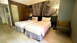 Postel nebo postele na pokoji v ubytování HORU HOTEL MANGGA DUA SQUARE
