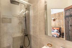 a bathroom with a shower and a mirror at La tanière du Cowboy in Orléans +17 photos