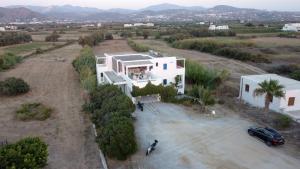 an aerial view of a white house with a car at Seaside stays and tours in Naxos, Greece in Naxos Chora