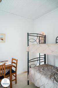 a bedroom with two bunk beds and a table at Asteria Apartments in Animborió