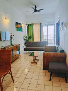 a living room with a couch and a table at Oceanwhite Homestay Corus in Port Dickson