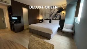 Postel nebo postele na pokoji v ubytování HORU HOTEL MANGGA DUA SQUARE