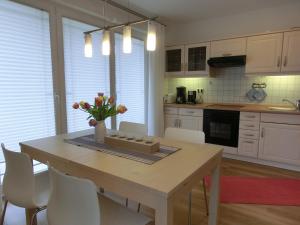 a kitchen with a table with a vase of flowers on it at Strandoase - FeWo 21 in Bansin