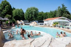 パランティ・アン・ボルヌにあるCamping 4 étoiles - Piscine - eebifgのプールにいる人々のグループ