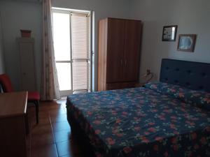 Postel nebo postele na pokoji v ubytování B&B Villa Le Palme Scalea