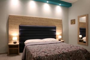 a bedroom with a large bed with a large headboard at Casa Michelangelo in Porto SantʼElpidio