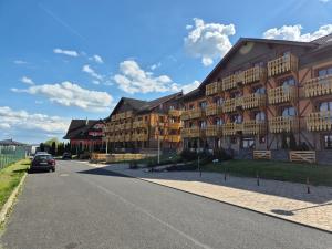 a car parked in front of a large building at High Tatras Apartment J303 in Veľká Lomnica