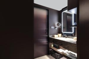 a bathroom with a sink and a mirror at Atour Hotel Dali Ancient Town March Street in Dali
