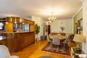 a living room with a table and a dining room at Ines Elysium in Kastoria