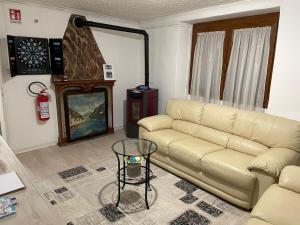 a living room with a couch and a table at Cà Rosina Casavacanze in Brusimpiano