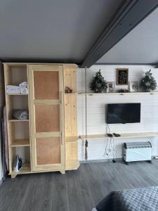 a living room with a tv and a cabinet at Dream House in Krivorovnya