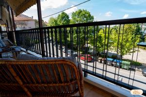 a balcony with a bench and a view of a street at Ines Elysium in Kastoria
