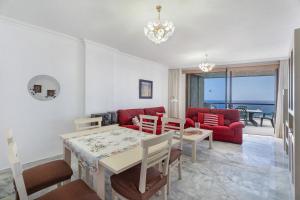 a living room with a table and a dining room at Al Mar Los Gigantes in Puerto de Santiago