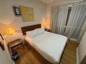 a small bedroom with a bed and a window at Gateways Apartment 6pax, Kuching Waterfront in Kuching +37 photos