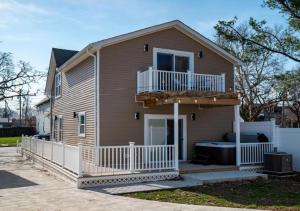 a house with a porch and a balcony at Hot Tub N64 Mins to Downtown Sleeps 8 in Cleveland