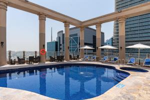 a swimming pool on the roof of a building at Oryx Hotel in Abu Dhabi
