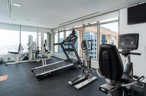 a gym with treadmills and machines in a building at Oryx Hotel in Abu Dhabi