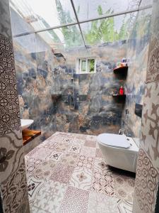 a bathroom with a tub and a toilet in a room at City Retreat Studio X in Arusha +57 photos
