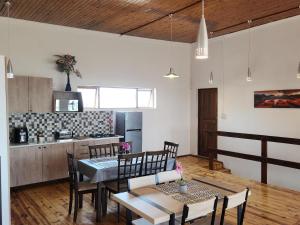 a kitchen and dining room with a table and chairs at Seaview Sunsets in Gqeberha +8 photos