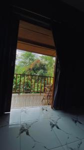 a room with a door open to a balcony at Poetri bungalow Superior ROOM in Mantaak