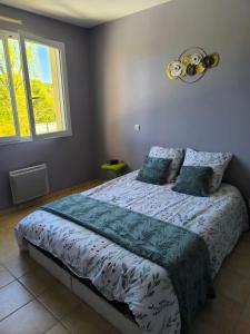 a bedroom with a bed with blue sheets and a window at 25 min du Puy du F, en sortant de Cholet in Le May-sur-Èvre