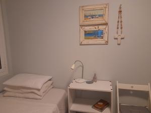 a small bedroom with a bed and a night stand at The Blue Door in Lixouri