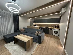 a living room with a couch and a table at Vimar Apartments in Panagyurishte