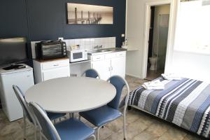 a small room with a table and a bed at Port Lincoln Caravan Park in North Shields