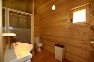 a wooden bathroom with a sink and a toilet at ZEcamping 3 étoiles animaux acceptés piscine et aire de jeux in Porto-Vecchio