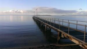 a large body of water with a pier at Port Lincoln Caravan Park in North Shields