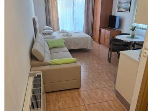 a living room with a couch and a bed at Apartmani Katarina in Makarska