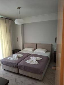 Postel nebo postele na pokoji v ubytování Palmyra Hotel