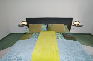 a bed with two lights on top of it at Haus Zinnauer in Velden am Wörthersee +19 photos