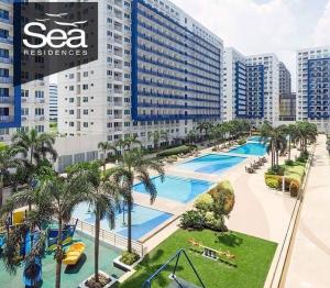 an aerial view of a resort with a swimming pool at Sea Residences MoA Manila by 7J in Manila