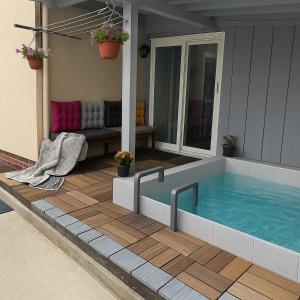 a swimming pool on the porch of a house at Guest House Red Rock in Žabljak