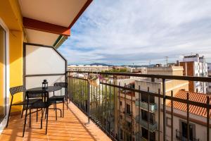 a balcony with a table and chairs on a building at Apartamento artístico Vilanova in Vilanova i la Geltrú