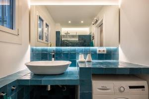 a bathroom with a blue counter with a sink at Apartamento artístico Vilanova in Vilanova i la Geltrú +17 photos