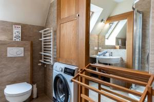 a bathroom with a washing machine and a sink at TatryTop Apartamenty Pardałówka in Zakopane +83 photos