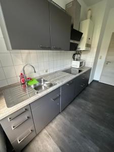 a kitchen with a sink and a counter top at Bezaubernde Ferien- und Monteurswohnung Nahe Leipziger Zentrum in Leipzig