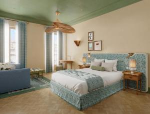 a bedroom with a bed and a ceiling fan at Hôtel Amista Marseille - ancien Hôtel Saint Louis - Vieux Port in Marseille