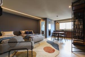 a living room with a bed and a table at Blue Loft - Two in Guarapuava