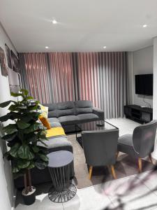 a living room with a couch and a table at 2 Bedroom combo with pool at Ocean Dune, Sibaya in Umdloti