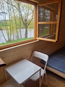 a table and a chair in a room with a window at Rybářský sen in Olbramkostel