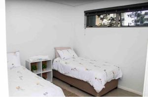 a bedroom with two beds and a window at 2 Bedroom combo with pool at Ocean Dune, Sibaya in Umdloti +34 photos