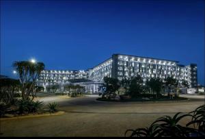 a large building with lights on it at night at 2 Bedroom combo with pool at Ocean Dune, Sibaya in Umdloti