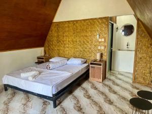 Postel nebo postele na pokoji v ubytování Bello Ethnic Bungalow & Resto