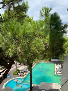 a view of a swimming pool with palm trees at Estia Seaview Apartment in Golem