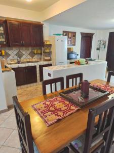 a kitchen with a wooden table with chairs and a tableasteryasteryasteryasteryastery at Casa Magnolia in Galtellì