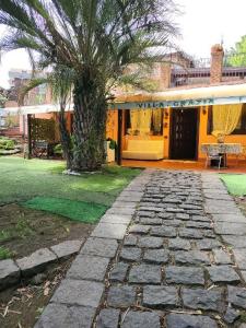 a palm tree in front of a house at Villa Grazia in Aci Catena